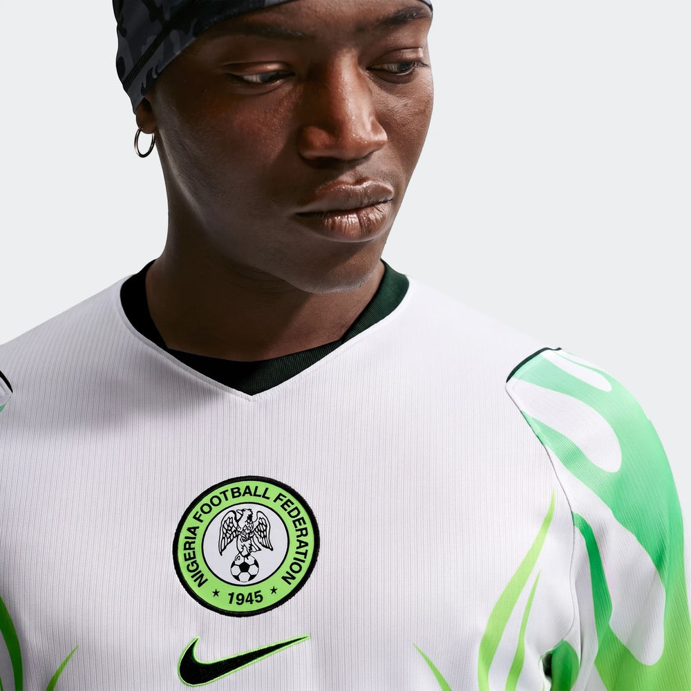 Nigeria 2026 Stadium Away Men's Nike Dri-Fit Soccer Replica Jersey. Close-up of white and green jersey with crest and Nike