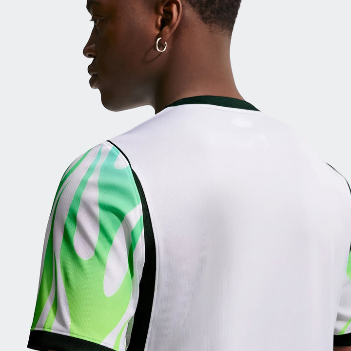 Back view of a male model wearing the white and green flame pattern Nigeria 2026 Stadium Away Men's Nike Dri-Fit Soccer