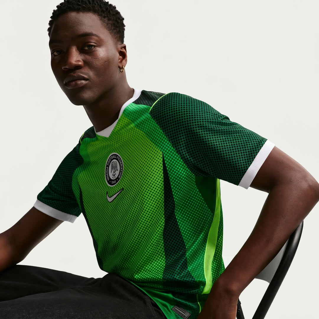 Nigeria 2026 Stadium Home Green Men's Nike Dri-Fit Soccer Short-Sleeve Jersey modeled by a man, showcasing the team crest.