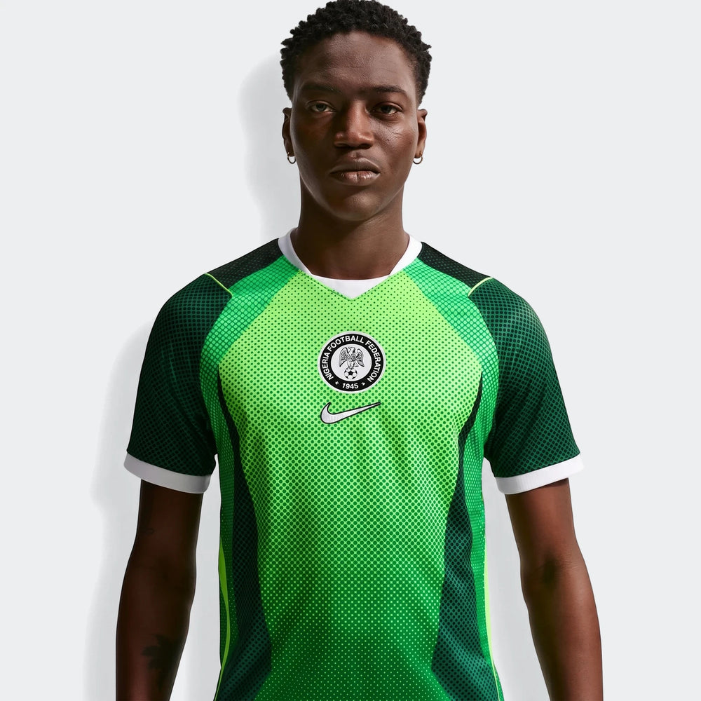 Nigeria 2026 Stadium Home Green Men'S Nike Dri-Fit Soccer Short-Sleeve Jersey worn by a model. Features a vibrant green and