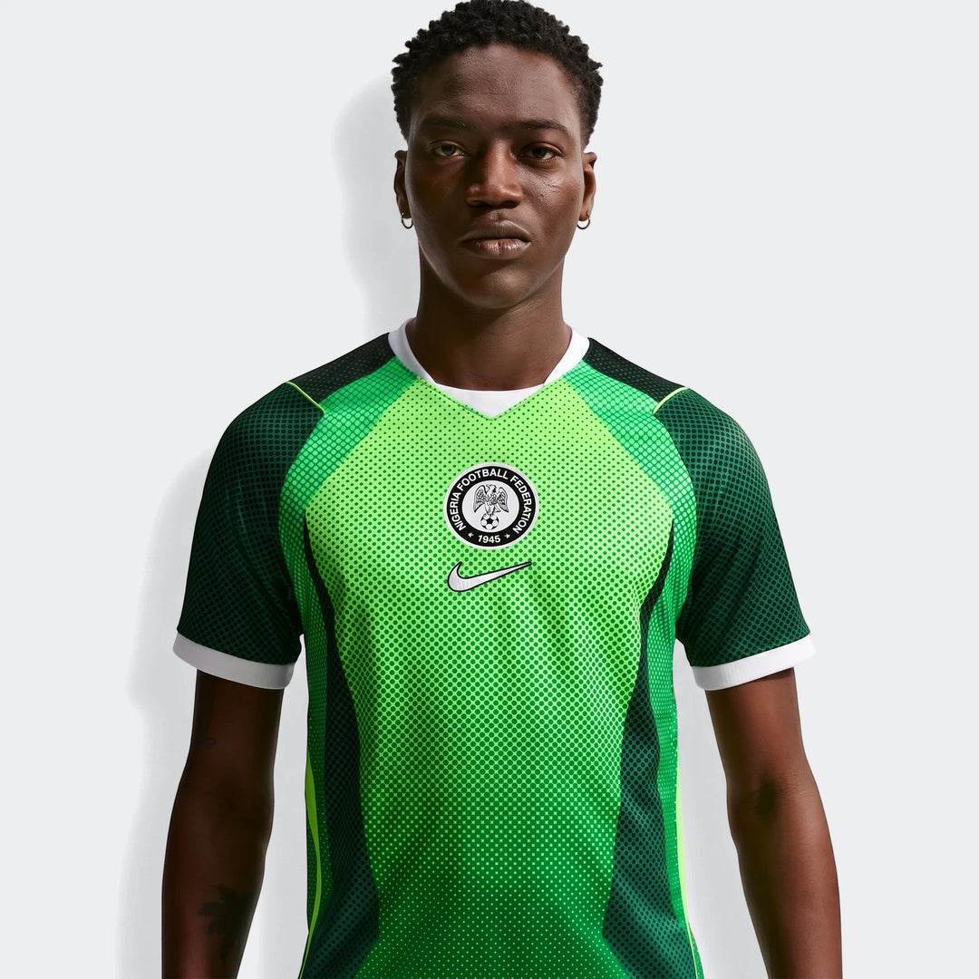 Nigeria 2026 Stadium Home Green Men'S Nike Dri-Fit Soccer Short-Sleeve Jersey worn by a model. Features a vibrant green and