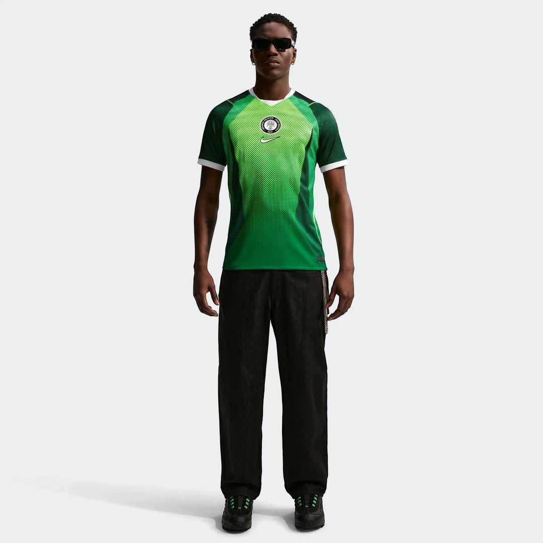 Full body view of a male model wearing the Nigeria 2026 Stadium Home Green Nike Dri-Fit Soccer Short-Sleeve Jersey.