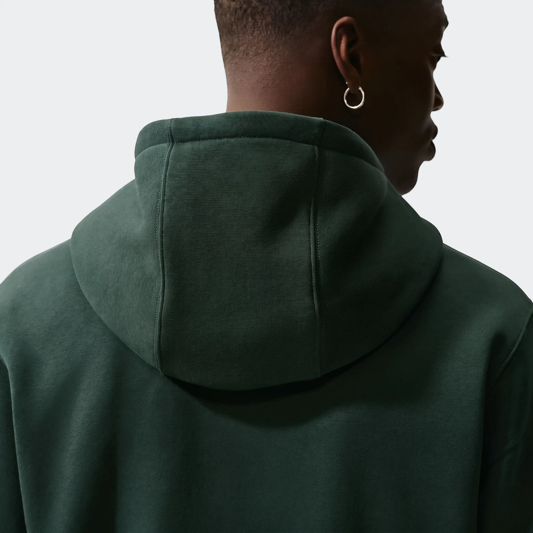 Nigeria Club Green Men's Nike Soccer Pullover Hoodie, shown from the back with visible hood and seams, worn by a model with