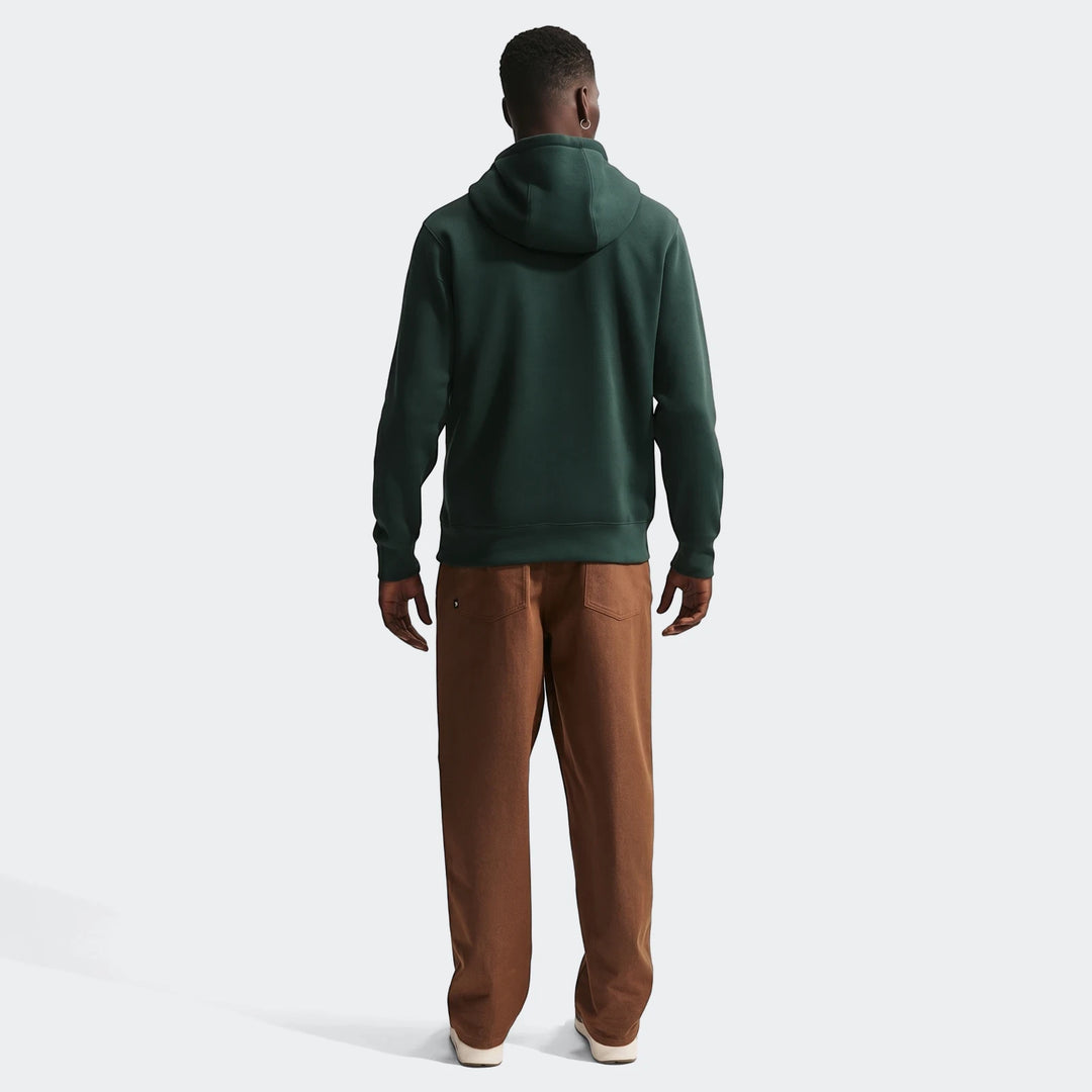 Men's Nigeria Club Green Nike Soccer Pullover Hoodie, dark green, shown from the back with brown pants.
