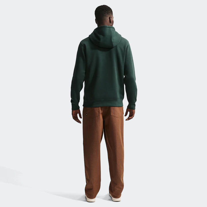 Men's Nigeria Club Green Nike Soccer Pullover Hoodie, dark green, shown from the back with brown pants.