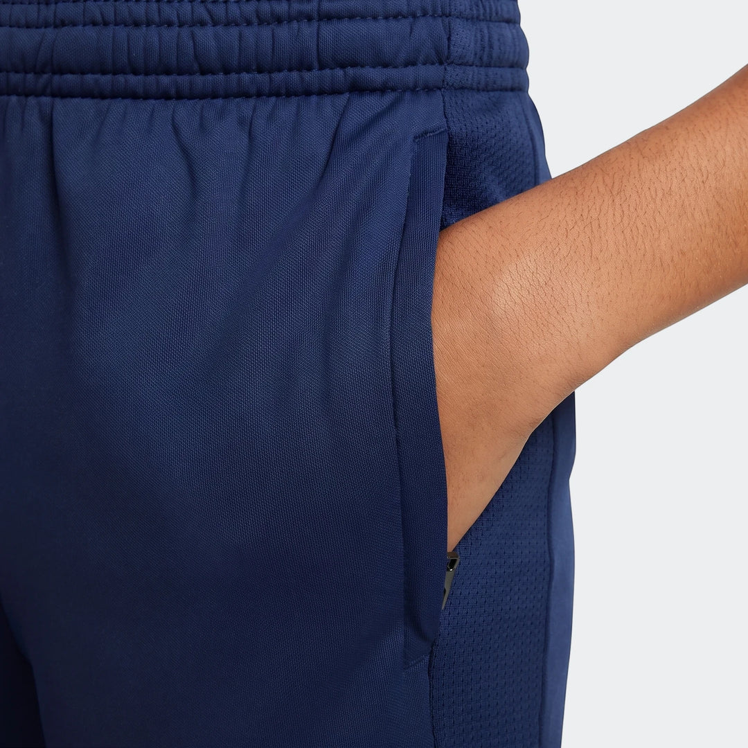Close-up of Nike Academy Big Kids' Dri-Fit Soccer Pants in navy blue, showing the pocket with a hand inside, and mesh detail.