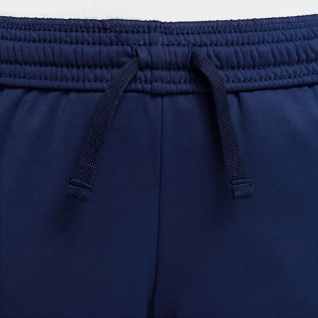 Navy blue Nike Academy Big Kids' Dri-Fit soccer pants, featuring an elastic waistband with a visible drawstring tie and