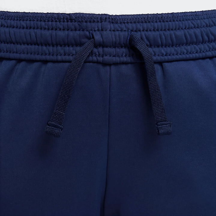 Navy blue Nike Academy Big Kids' Dri-Fit soccer pants, featuring an elastic waistband with a visible drawstring tie and