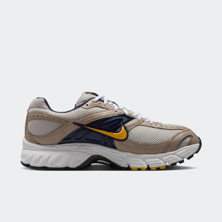 Nike Air Max Moto 2K 2Tone men's running shoes in beige, dark blue, and yellow, shown from a side view.