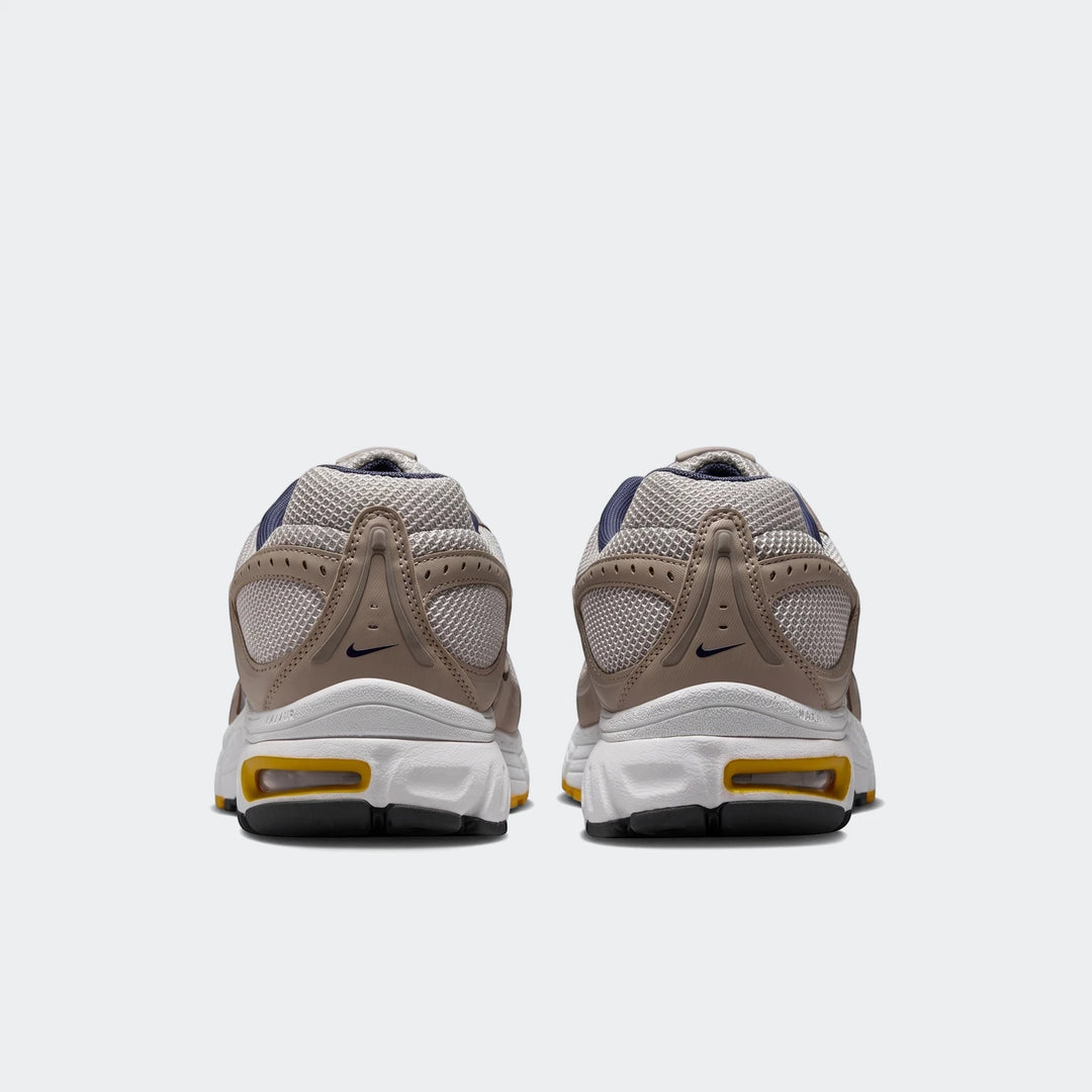 Rear view of Nike Air Max Moto 2K 2Tone men's shoes in beige and white with mesh details.