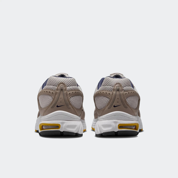 Rear view of Nike Air Max Moto 2K 2Tone men's shoes in beige and white with mesh details.