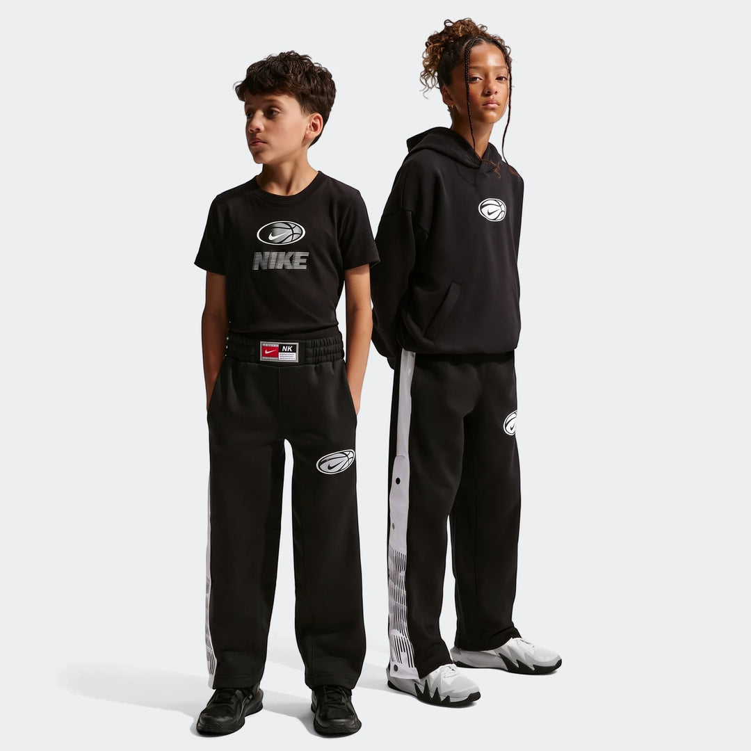 Two children wearing black Nike Big Kids' Basketball Pants with white side stripes, black t-shirt, and black hoodie. Full