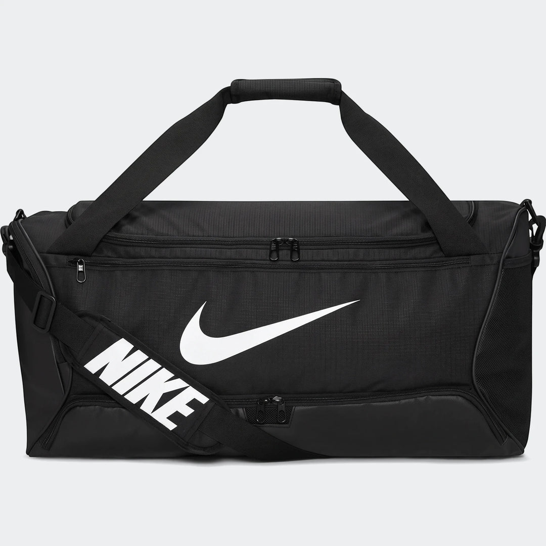 Black Nike Brasilia 95-liter duffel bag with white Nike swoosh logo and 'NIKE' text on the shoulder strap, front view.