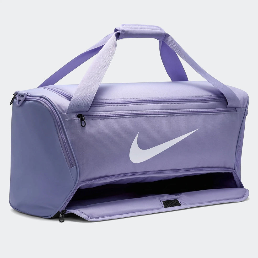 Purple Nike Brasilia Medium Duffel Bag shown from a front angle with an open side pocket and carrying handles.