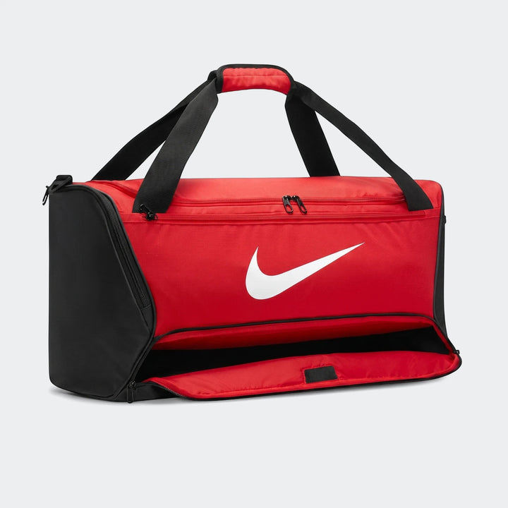 Red and black Nike Brasilia Medium Duffel Bag with an open front compartment, featuring a prominent white Nike swoosh logo.