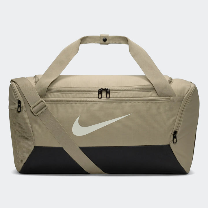 A brown Nike Brasilia 9.5 small duffel bag with black bottom panel, white swoosh logo, and shoulder strap, displayed on a