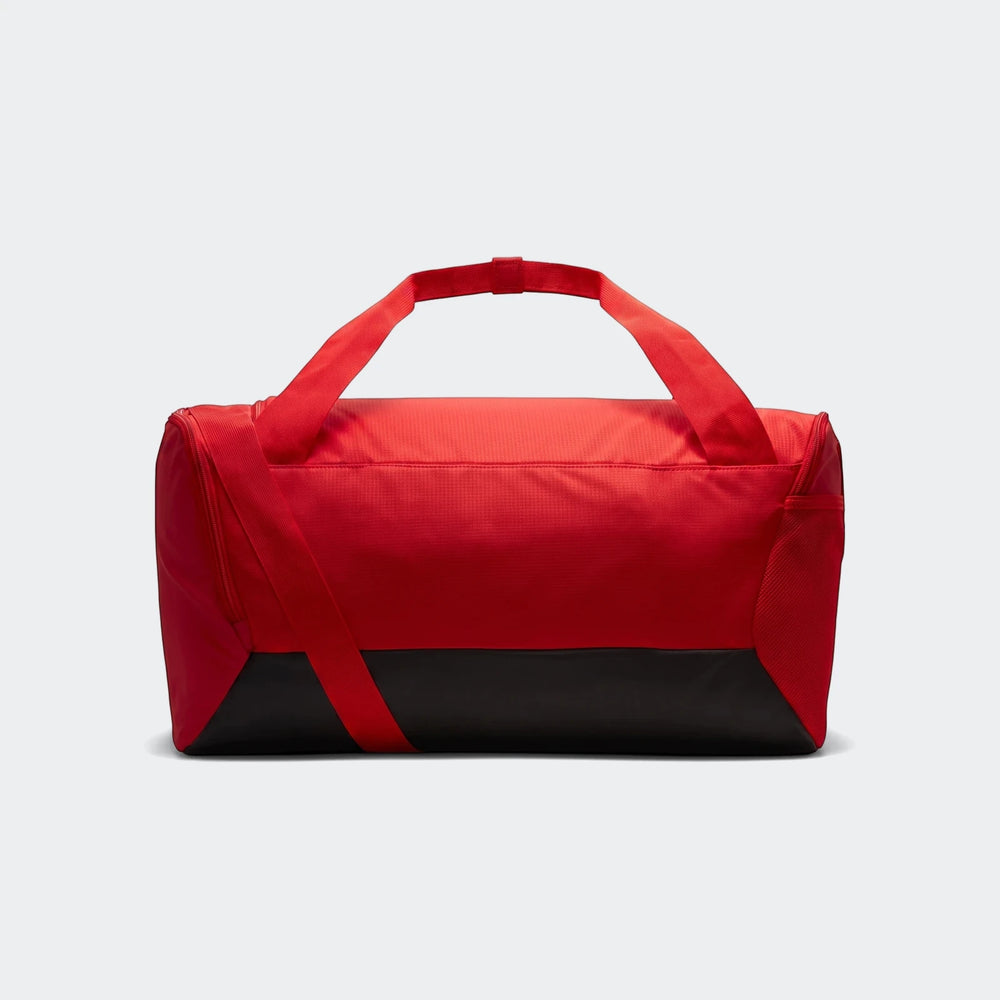 Red and black Nike Brasilia S Duff 9.5 duffel bag with carrying straps and a top zipper closure, presented from a