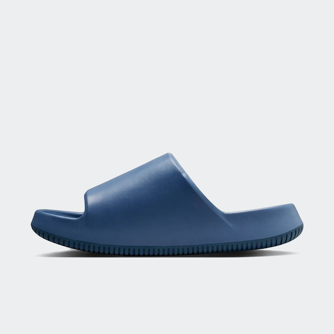 Blue Nike Calm 2.0 Men's Slides in a side view, featuring a smooth, contoured design and a comfortable sole.