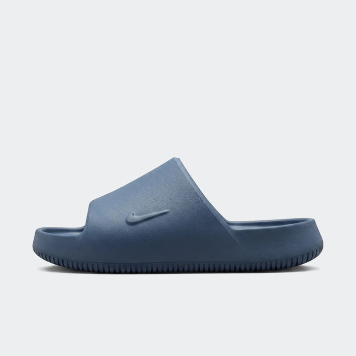 Deep blue Nike Calm 2.0 Men's Slides in a side profile view, showcasing their comfortable, minimalist design.