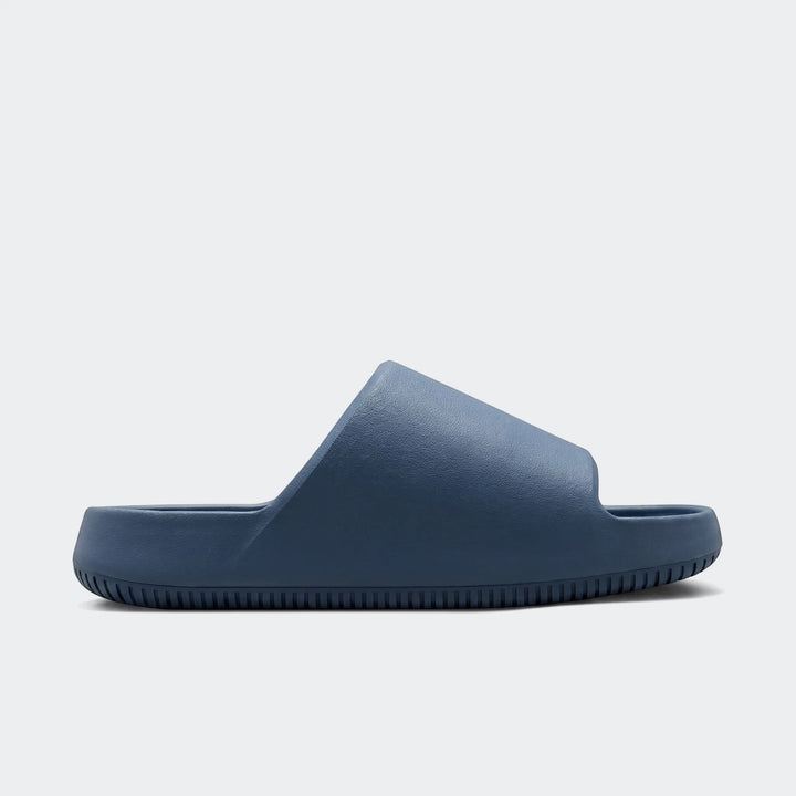 Nike Calm 2.0 Men's Slides in a navy blue color, featuring a comfortable, minimalist design viewed from the side profile.