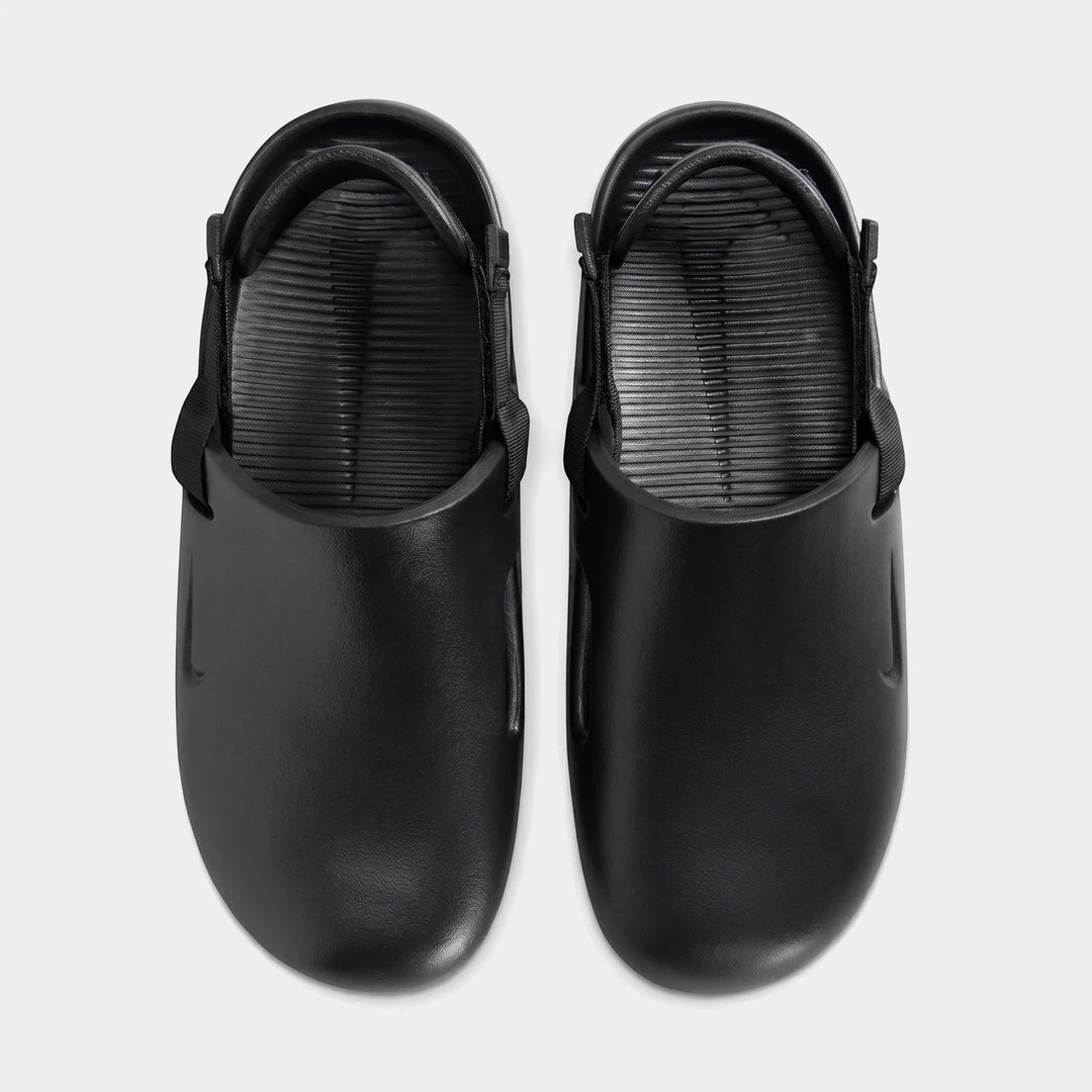 Pair of black Nike Calm men's mules, showcasing the top-down view of the smooth rubber-like material and textured footbed.