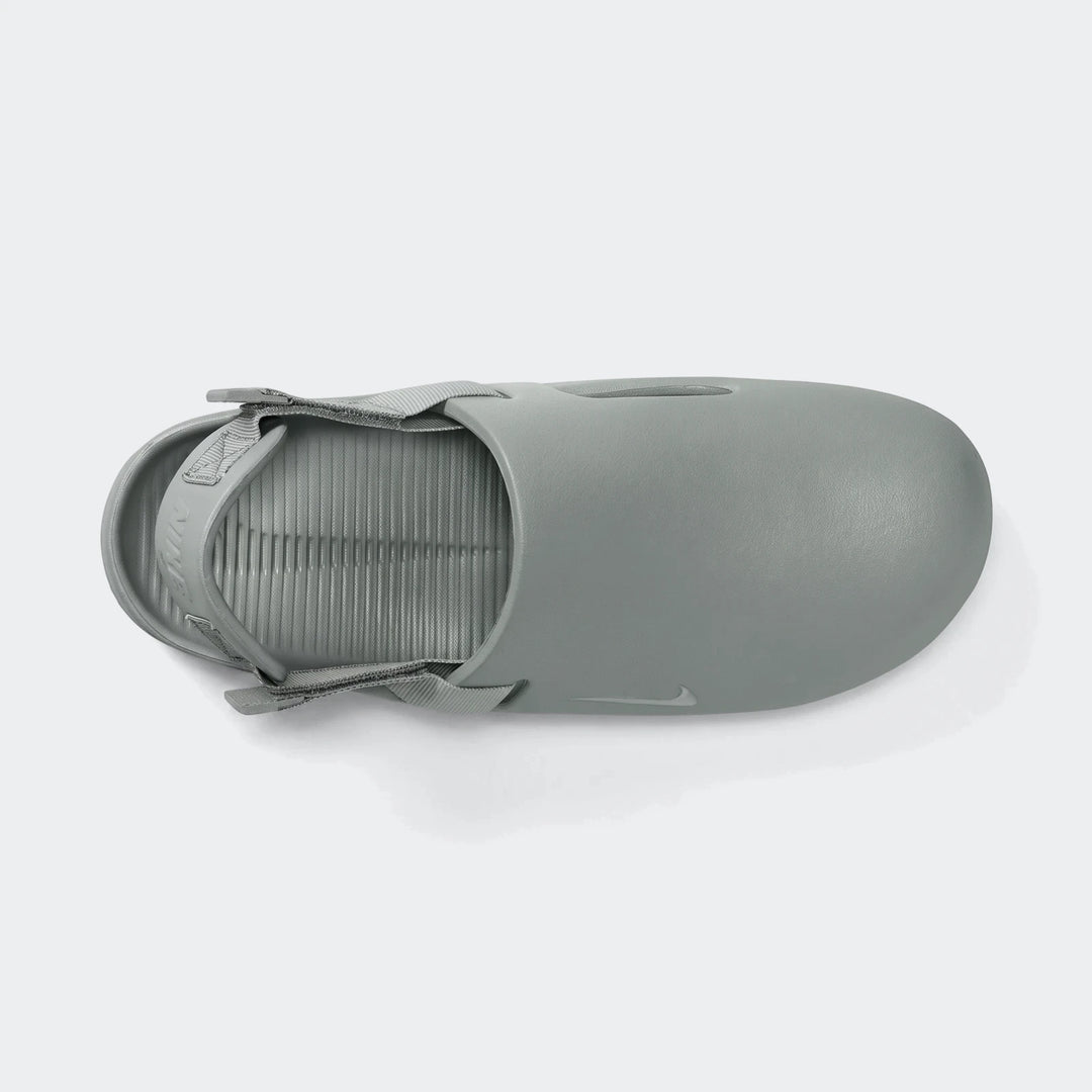 Gray Nike Calm Men's Mules, featuring a smooth, matte finish and a ribbed footbed, shown from a top-down perspective.