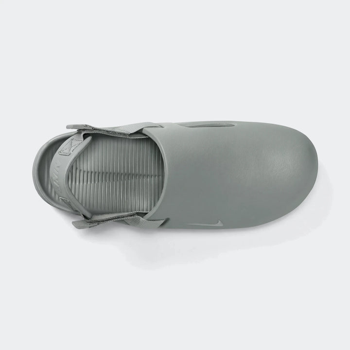 Gray Nike Calm Men's Mules, featuring a smooth, matte finish and a ribbed footbed, shown from a top-down perspective.