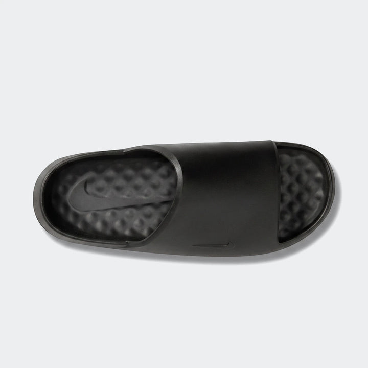 Nike Calm Slide 2.0 black rubber slides, viewed from above on a white background, featuring a textured footbed and sleek