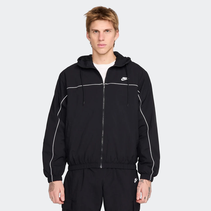 Men's Nike Club black hooded jacket with white stripes and a full-zip front, worn by a model.