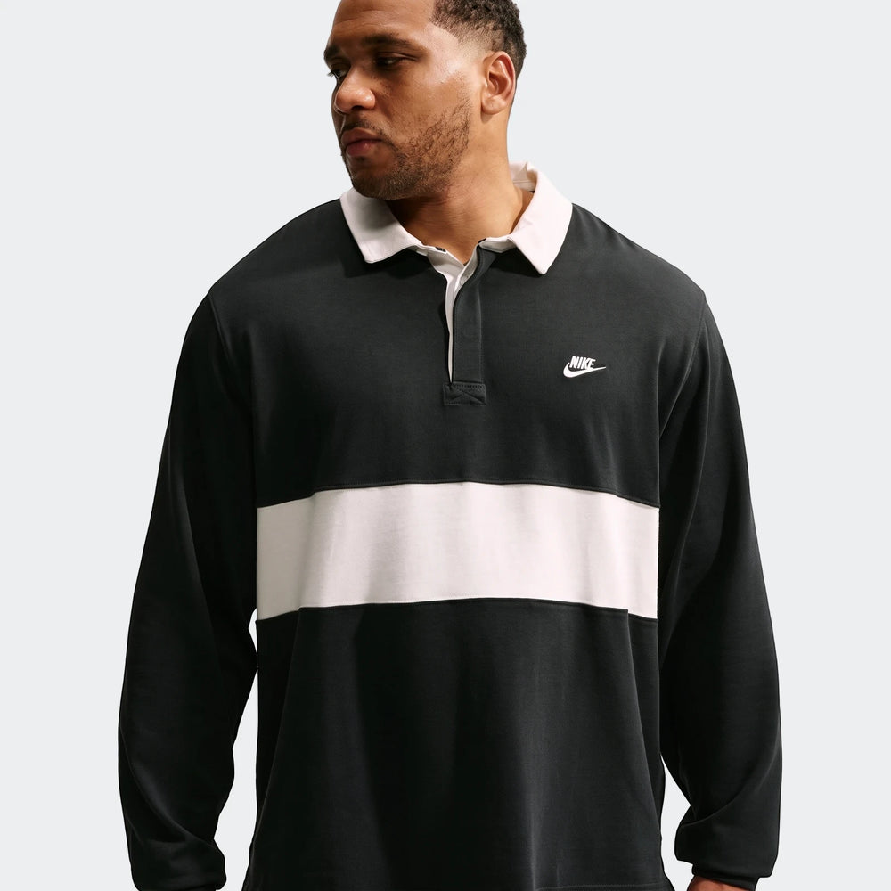 Black and off-white striped Nike Club Men's Long-Sleeve Rugby Top, worn by a model shown from the chest up.