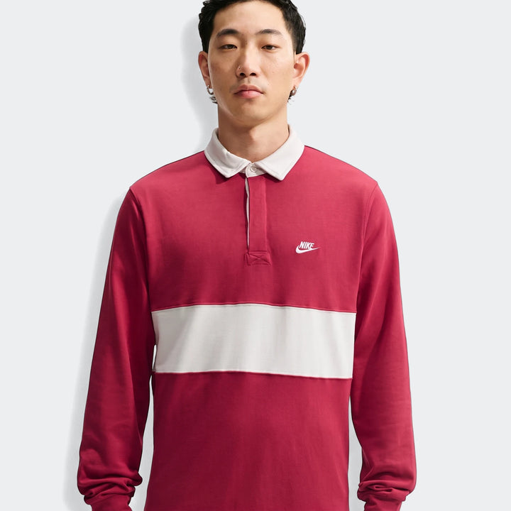 Nike Club Men's Long-Sleeve Rugby Top in red with a white horizontal stripe, worn by a male model.