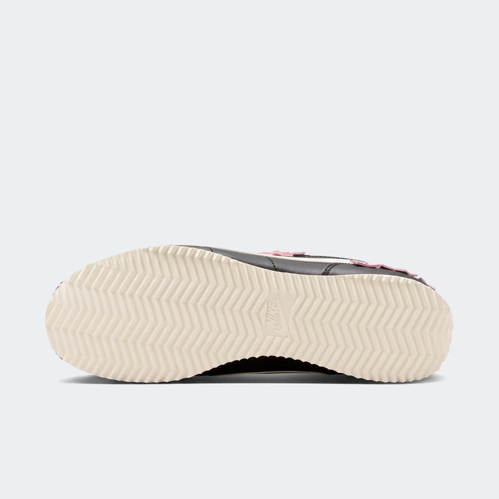 Nike Cortez Leather Women's Shoes in black and pink with an off-white sole, captured from a low angle showing the detailed