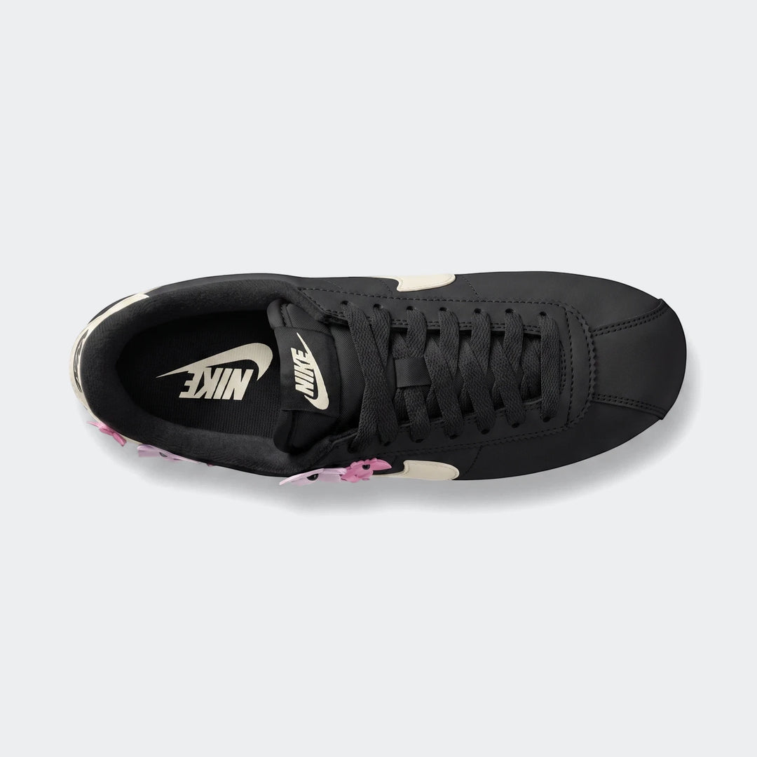 Nike Cortez Leather Women's Shoes in black with white swoosh, captured from a top-down perspective on a clean background.