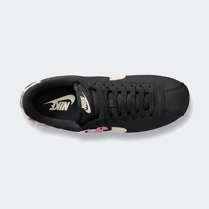 Nike Cortez Leather Women's Shoes in black with white swoosh, captured from a top-down perspective on a clean background.