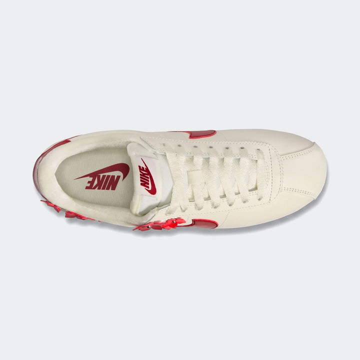 Nike Cortez Leather Women's Shoes in off-white with red accents, presented in a top-down view.