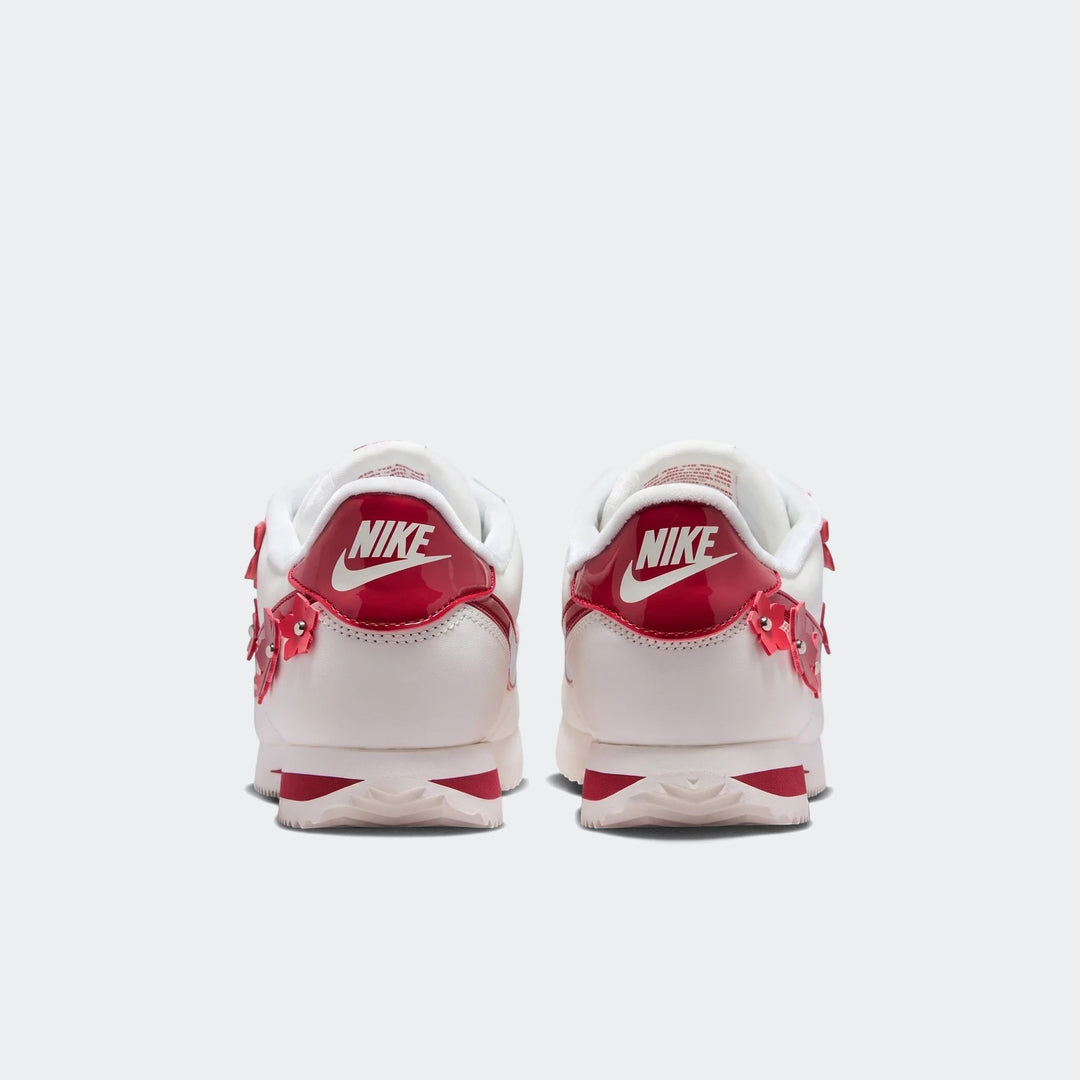 Rear view of Nike Cortez Leather Women's Shoes in white and red, featuring white leather, red patent leather accents, and