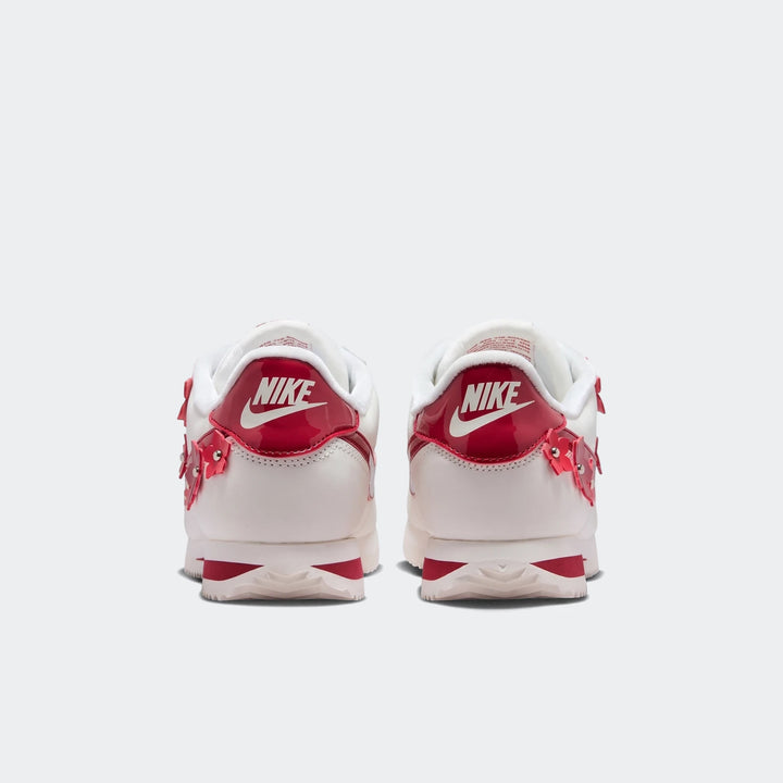Rear view of Nike Cortez Leather Women's Shoes in white and red, featuring white leather, red patent leather accents, and