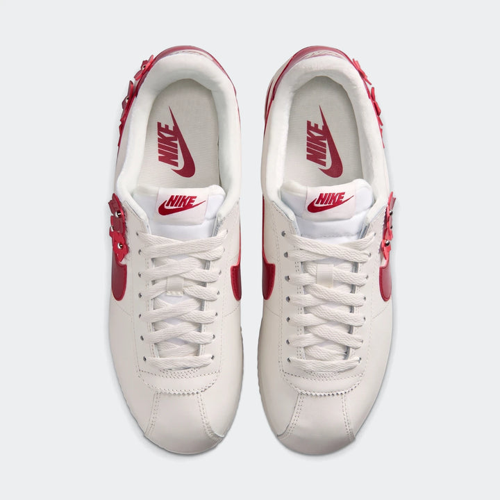 Top-down view of white Nike Cortez Leather Women's Shoes with red details and floral embellishments.
