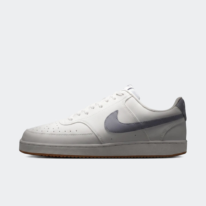 A white Nike Court Vision Low men's shoe with a gray swoosh logo on the side, photographed from a side view.