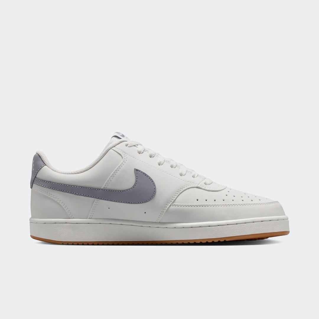 Nike Court Vision Low men's shoes in white with a prominent grey swoosh and a classic brown gum sole, presented in a side