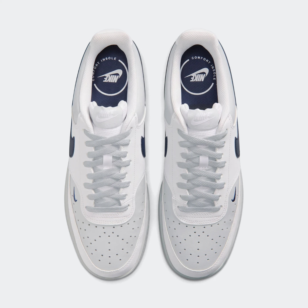 Top-down view of Nike Court Vision Low Men's Shoes. White and light grey leather upper, navy blue accents, and light blue