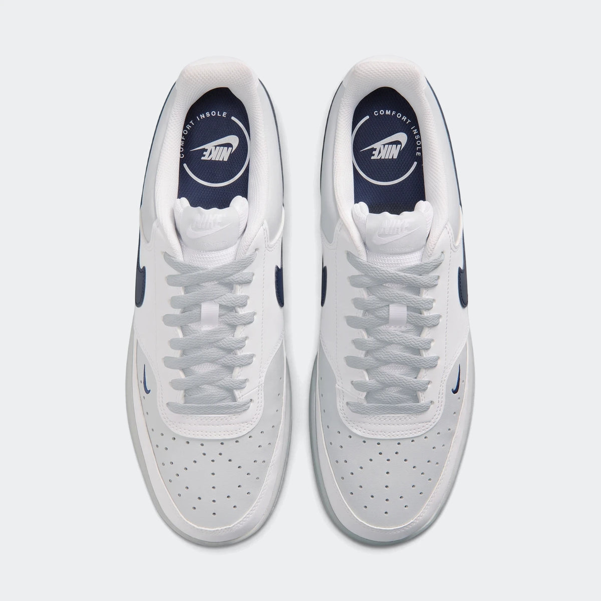 Top-down view of Nike Court Vision Low Men's Shoes. White and light grey leather upper, navy blue accents, and light blue