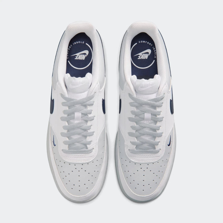 Top-down view of Nike Court Vision Low Men's Shoes. White and light grey leather upper, navy blue accents, and light blue