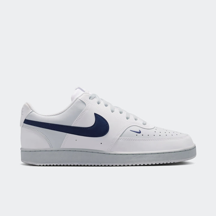 Nike Court Vision Low men's shoes in white with a navy blue swoosh logo, shown in a side view as a low-top sneaker.