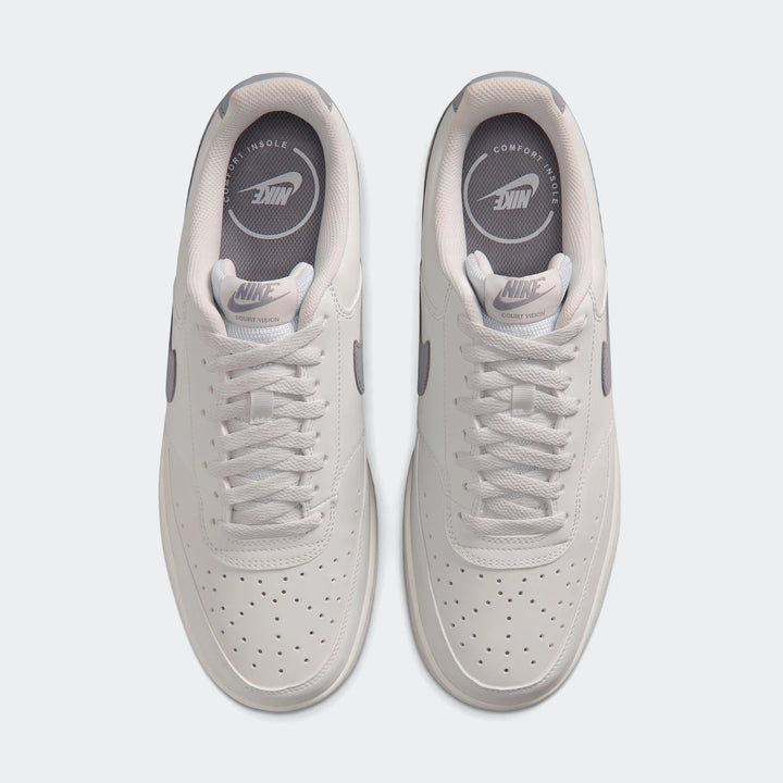 Top-down view of white Nike Court Vision Low men's shoes with gray accents, perforated toe box, and white laces.