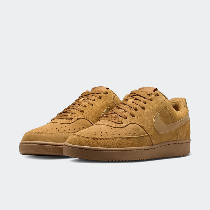 Pair of Nike Court Vision Low Suede Premium Men's Shoes in tan, featuring a low-top design, shown from a side view.