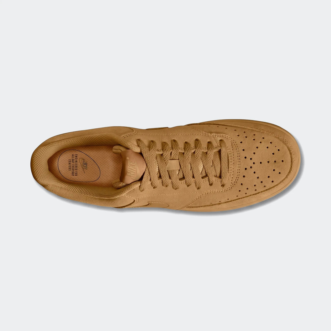 Tan suede Nike Court Vision Low Premium men's shoe, viewed from above, showcasing its laces and perforated toe box.