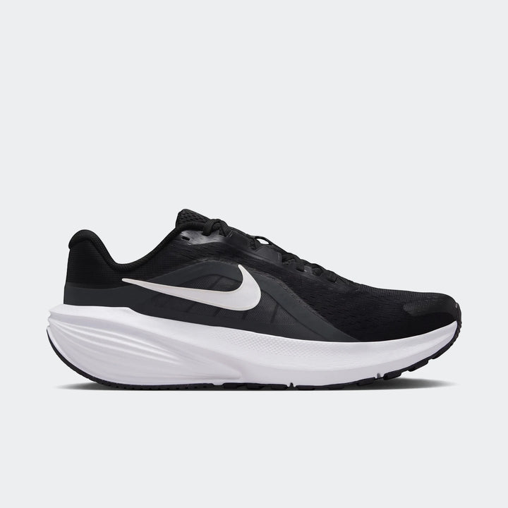 Nike Downshifter 14 men's road running shoe in black and white, presented in a side view.