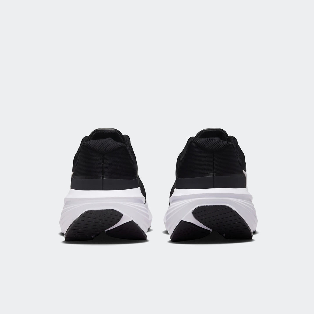 Rear view of Nike Downshifter 14 Men's Road Running Shoes in black and white, showcasing the heel and sole design.