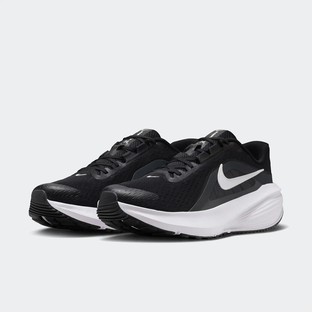 Pair of Nike Downshifter 14 men's road running shoes in black with white soles and swoosh, angled view.